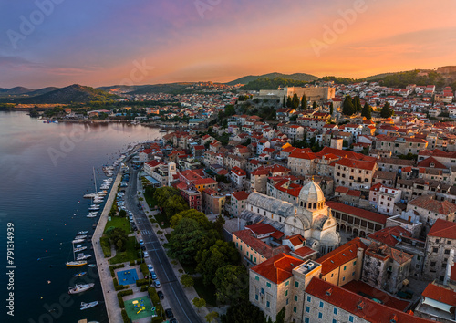 Sibenik, Croatia - Aerial view of the mediterranean old town of Sibenik on a sunny summer morning with Saint James Cathedral, Fortress of Saint Michael and dramatic golden sunrise by the Adriatic sea