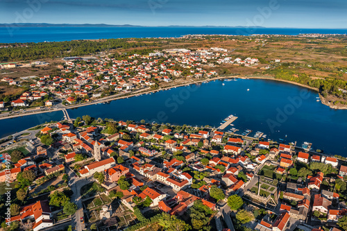 Nin, Croatia - Aerial panoramic view of the historic town and small island of Nin with blue Adriatic sea on a sunny summer morning in Dalmatia region of Croatia photo