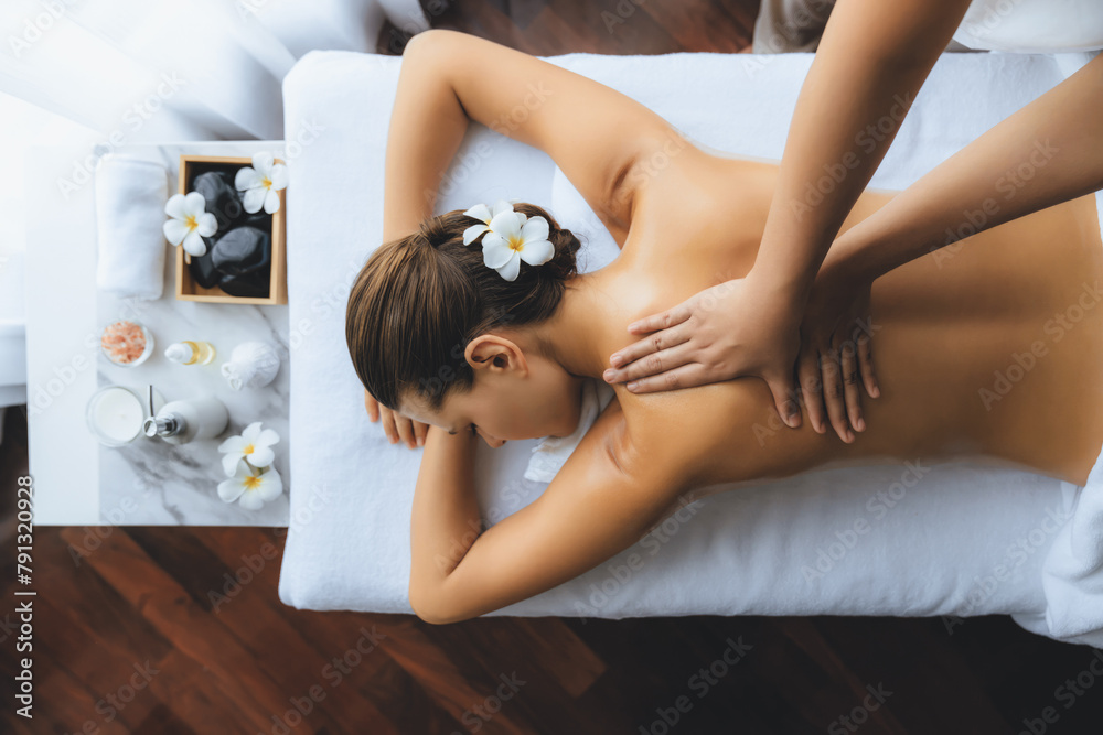 Naklejka premium Panorama top view woman customer enjoying relaxing anti-stress spa massage and pampering with beauty skin recreation leisure in day light ambient salon spa at luxury resort or hotel. Quiescent