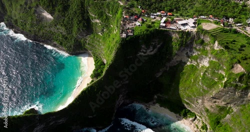 Restaurants And Hotels On The Clifftop With Kelingking And Embon Beach In Nusa Penida Island, Bali, Indonesia. - aerial shot photo