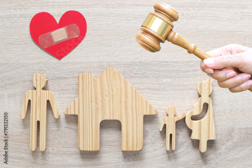 Divorce lawyer Or Attorney, Husband and wife splitting children on wooden background,Joint child custody and alimony concept.
