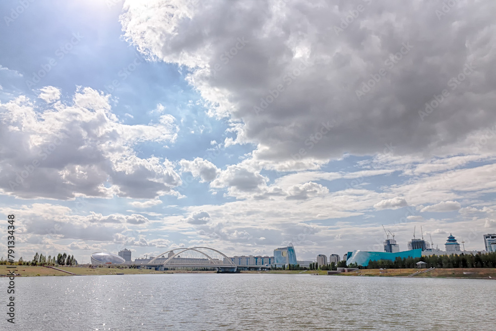 Astana, Kazakhstan - September 6, 2016: View of the bridge from the embankment of the Ishim River. HDR