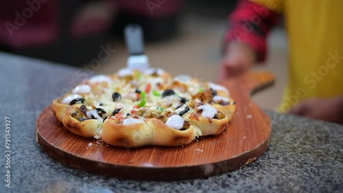 Pizza chef serving freshly baked pizza photo