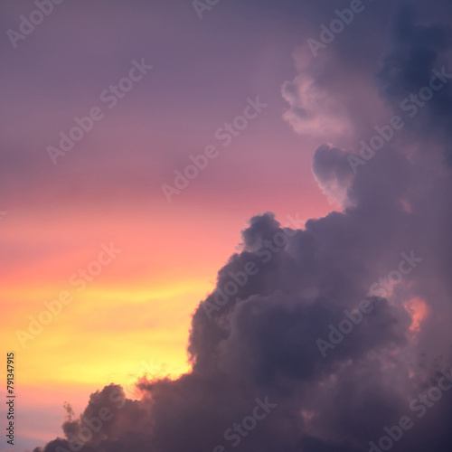 Sunset sky clouds at dusk with pink, yellow and purple sunlight after sundown or golden hour. Romantic twilight sky in the evening of summer season. Use for background or backdrop in nature concept