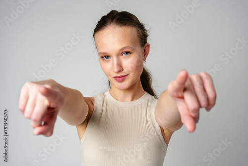Young Woman in Tank Top Pointing at Camera