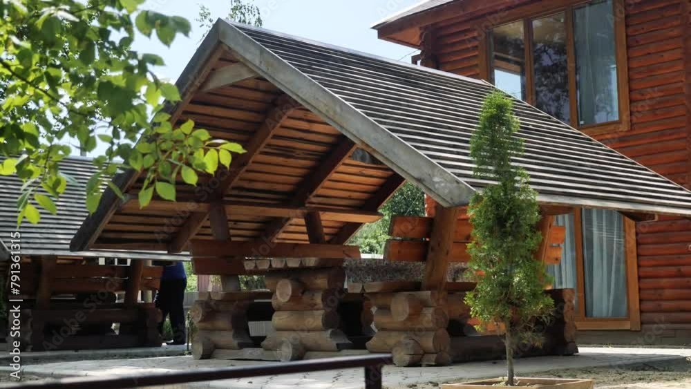 Picturesque open wooden houses, gazebos with a roof for relaxation, celebrations and barbecues among tall trees in the park on a sunny day. Camping in the forest
Picturesque open wooden houses, gazebos with a roof for relaxation, celebrations and barbecues among tall trees in the park on a sunny day. Camping in the forest
