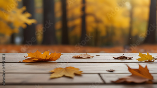 Autumn leaves scattered on a empty wooden table surface