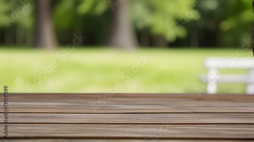 Wooden table on grass in a sunlit park with blurred nature background