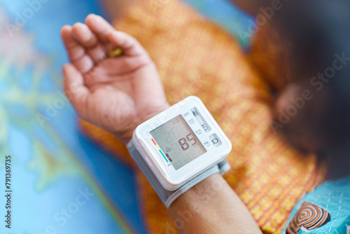 Self-measurement of blood pressure using a device on the wrist of the elderly. photo