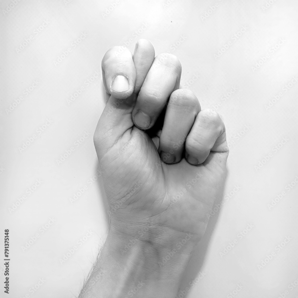 Letter T in American Sign Language (ASL) for deaf people, black and white photo of a hand Letter T in American Sign Language (ASL) for deaf people, black and white photo of a hand