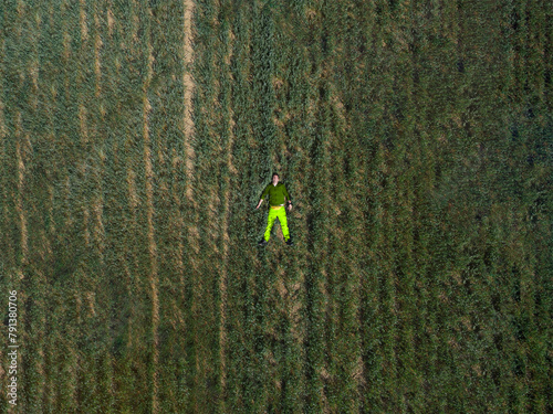 A man laying in a green field