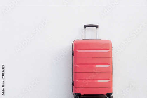 Pink travel suitcase on white background. Summer and vacations. Weekend. Travel.