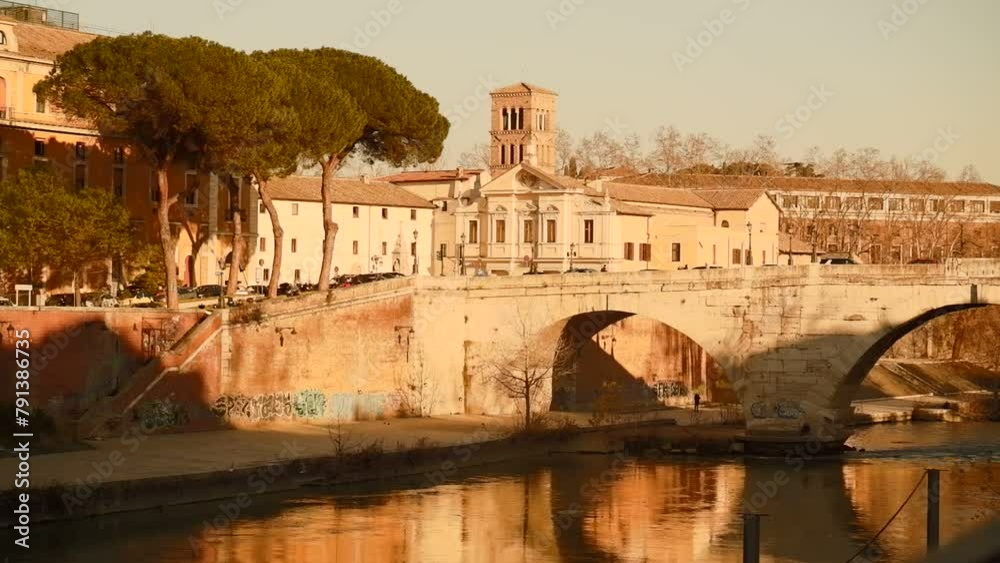 Rome, Tiber Island panoramic view on the river at sunset, buildings and synagogue in cityscape Rome, Tiber Island panoramic view on the river at sunset, buildings and synagogue in cityscape