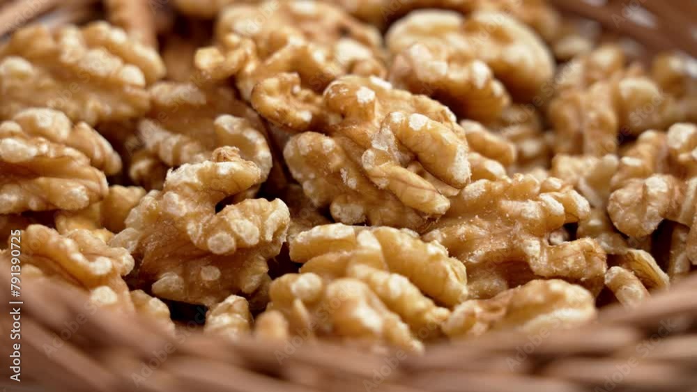 Organic walnut kernels nuts in rustic rattan wicker bowl. Peeled bio seeds. Nutritious ingredient. Rotation Organic walnut kernels nuts in rustic rattan wicker bowl. Peeled bio seeds. Nutritious ingredient. Rotation