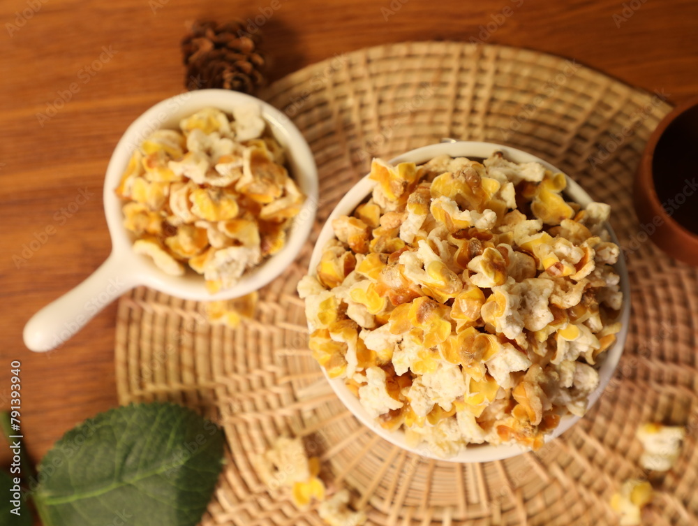 Popcorn for a plate and a cup of dipping sauce Popcorn for a plate and a cup of dipping sauce