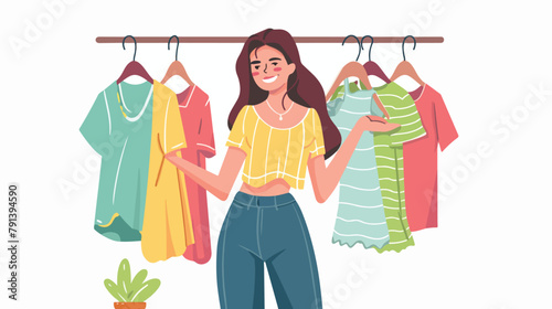 Cute young woman standing in front of hanger rack
