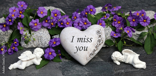 Heart with flowers as a grave decoration with the saying I miss you.