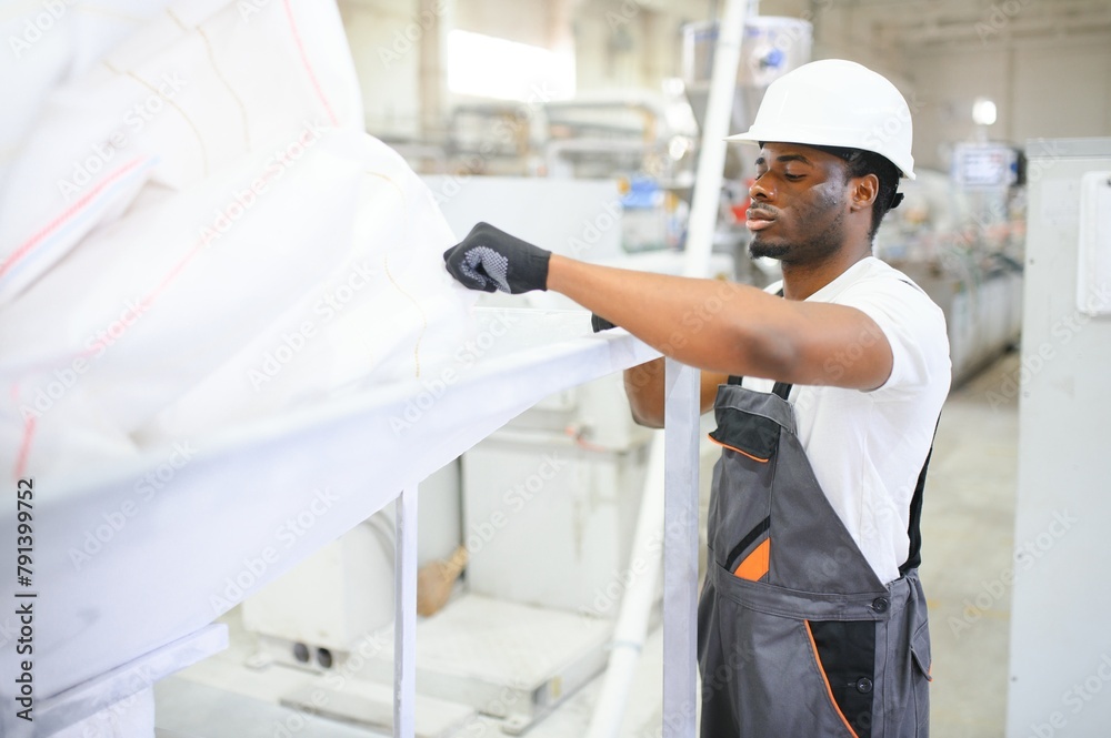 Professional Heavy Industry Engineer Worker Wearing Uniform, Glasses and Hard Hat in a Factory Professional Heavy Industry Engineer Worker Wearing Uniform, Glasses and Hard Hat in a Factory