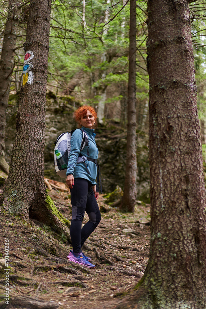 Woman hiking on a trail in the mountains Woman hiking on a trail in the mountains