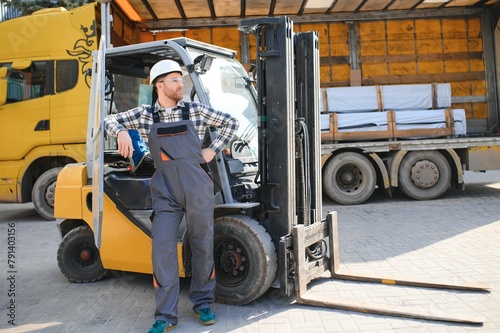 Man worker at forklift driver happy working in industry factory logistic ship