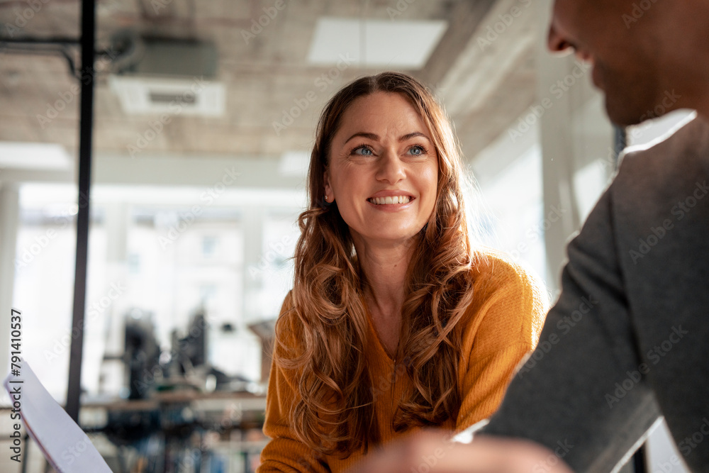 Happy mature businesswoman with colleague in office Happy mature businesswoman with colleague in office