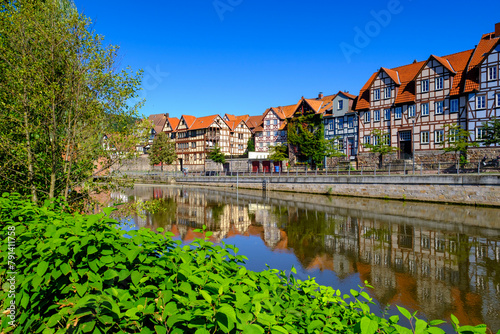 Germany, Lower Saxony, Hannoversch Munden, Row of historic houses along Fulda river in summer photo