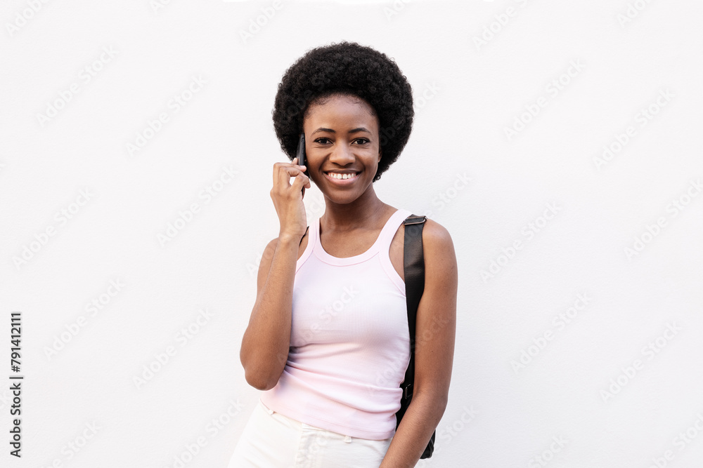 Smiling woman talking on smart phone against white background Smiling woman talking on smart phone against white background