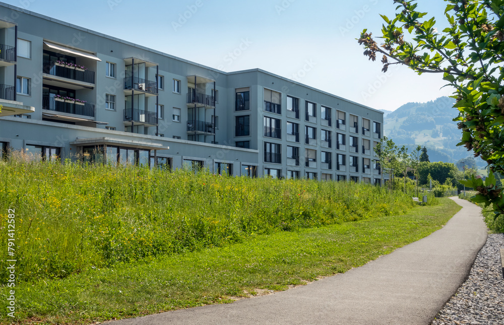 Switzerland, St Gallen Canton, Kaltbrunn, Green grass in front of modern energy efficient apartment house Switzerland, St Gallen Canton, Kaltbrunn, Green grass in front of modern energy efficient apartment house