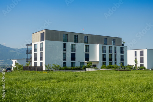 Switzerland, St Gallen Canton, Kaltbrunn, Green grass in front of modern energy efficient apartment house photo