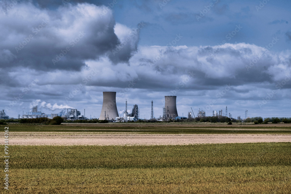 HDR Oil refinery, cooling towers and a cloudy sky.