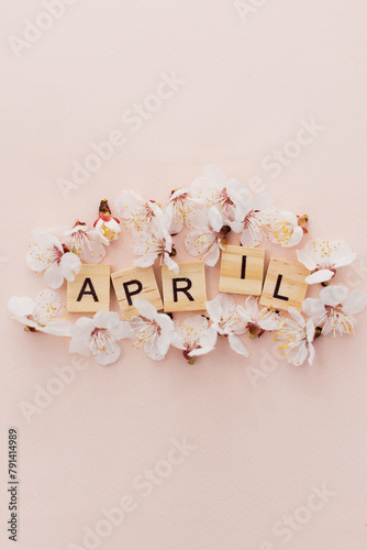 Wooden letter tiles surrounded by apricot blossoms