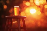 Glass of beer on a bar stool on a bokeh background