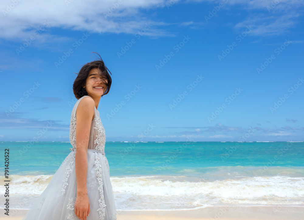 Teen girl in white dress walking barefoot on hawaiian beach Teen girl in white dress walking barefoot on hawaiian beach