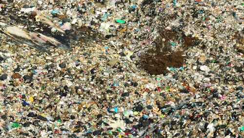 A chaotic mix of trash with varied textures and colors, highlighting environmental concerns related to waste management. Garbage background. Aerial view. 