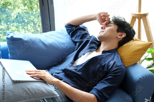 Young man take a nap after overworked at home
