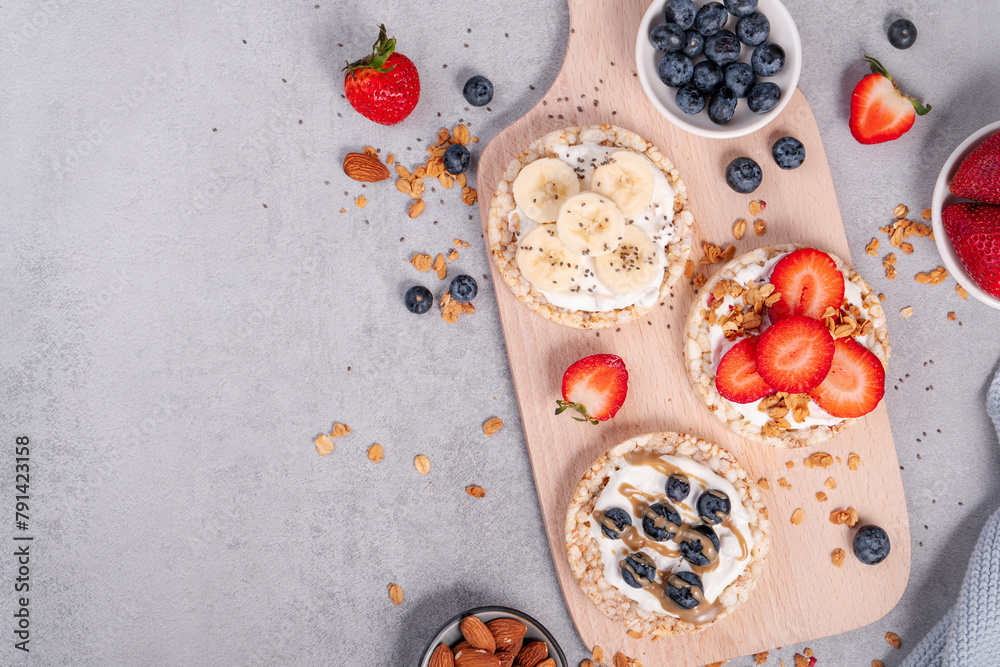 Rice Crackers Healthy Snack, Crackers Topped with Banana, Fresh Berries, Yogurt and Granola, Breakfast Idea Rice Crackers Healthy Snack, Crackers Topped with Banana, Fresh Berries, Yogurt and Granola, Breakfast Idea