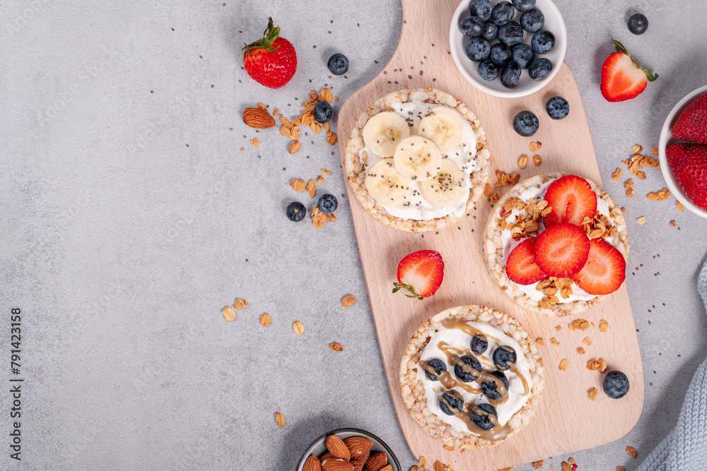 Rice Crackers Healthy Snack, Crackers Topped with Banana, Fresh Berries, Yogurt and Granola, Breakfast Idea