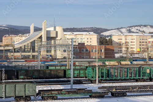Freight trains at the railway station. View of freight cars and the station. Cargo delivery by rail. Baikal-Amur Mainline (BAM). Severobaikalsk city, Republic of Buryatia, Siberia, Russia.