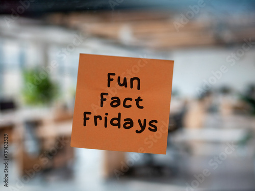 Post note on glass with 'Fun Fact Fridays', team building, game at work, office game, fun in enterprise.