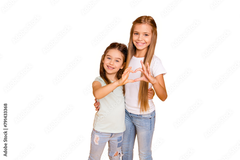 Portrait of two nice adorable stylish trendy attractive lovely sweet cheerful cheery positive caucasian pre-teen girls showing health healthy heart isolated over bright vivid shine yellow background Portrait of two nice adorable stylish trendy attractive lovely sweet cheerful cheery positive caucasian pre-teen girls showing health healthy heart isolated over bright vivid shine yellow background