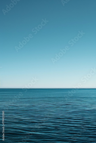 The vastness of the ocean stretching out to the horizon  with just the line where the sea meets the sky in the frame.