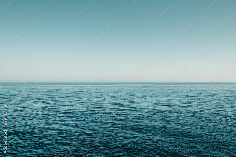 Fototapeta premium The vastness of the ocean stretching out to the horizon, with just the line where the sea meets the sky in the frame.