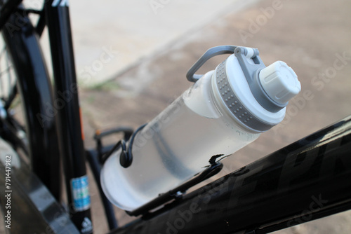 Close-up of a water bottle on a bicycle