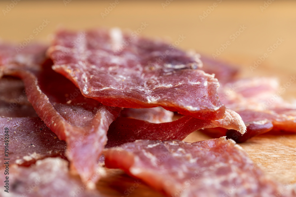 Obraz premium dried pork meat with spices and salt on the table