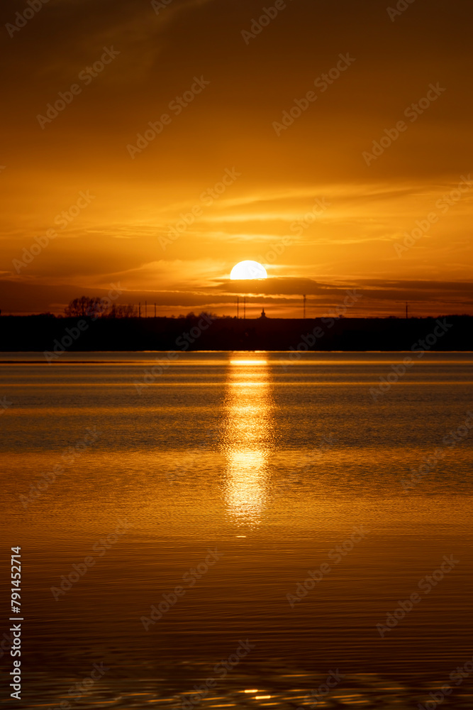 The sky and the lake are red-tinged during sunset The sky and the lake are red-tinged during sunset