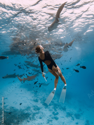 Woman freediver in a tropical water with nurse sharks in Maldives © artifirsov