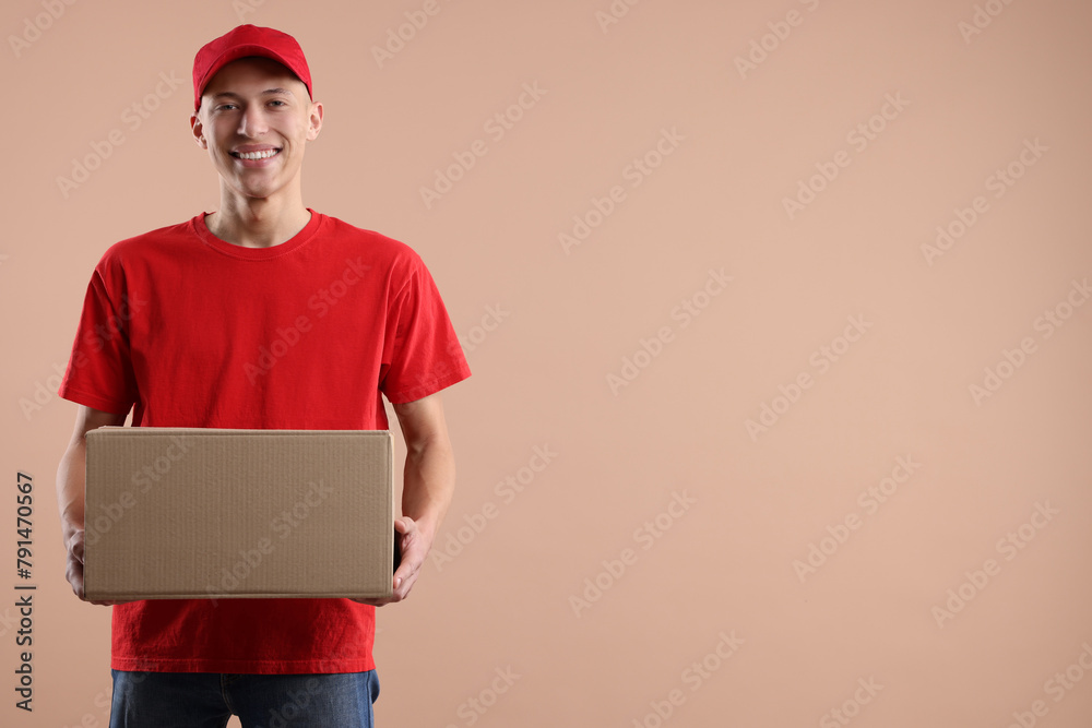 Happy courier with parcel on beige background. Space for text Happy courier with parcel on beige background. Space for text
