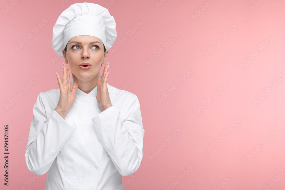 Confused woman chef in uniform on pink background, space for text Confused woman chef in uniform on pink background, space for text