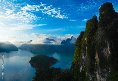 The green area at Khao Sok national park Cheow Lan Dam lake with blue sky background in Surat Thani, Thailand.