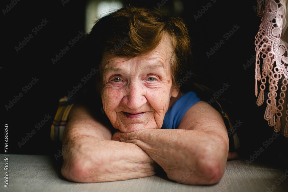 Expressive close-up portrait captures intricate details of the elderly woman's face, revealing a lifetime of stories in every wrinkle and line. Her eyes convey depth and wisdom, inviting reflection. - obrazy, fototapety, plakaty 